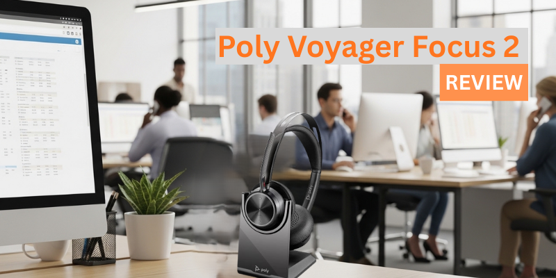 black poly voyager focus 2 uc headset in charging stand on a table in a busy office